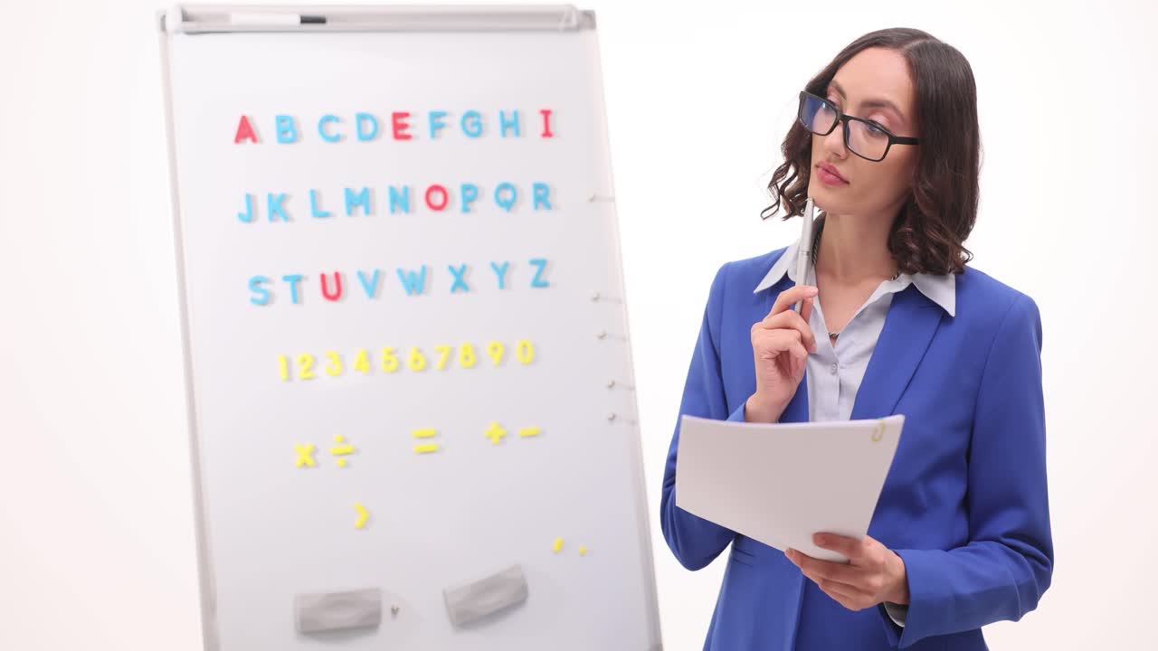 Teacher explaining alphabet and numbers