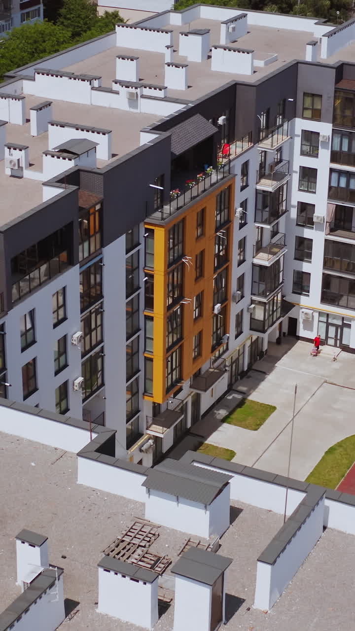 Aerial View Of Luxury Apartment Buildings. Contemporary apartment building with colorful walls of the facade. Vertical video