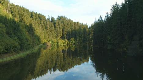 4K-Drone-Shot---Peaceful-small-Austrian-lake-surrounded-by-trees