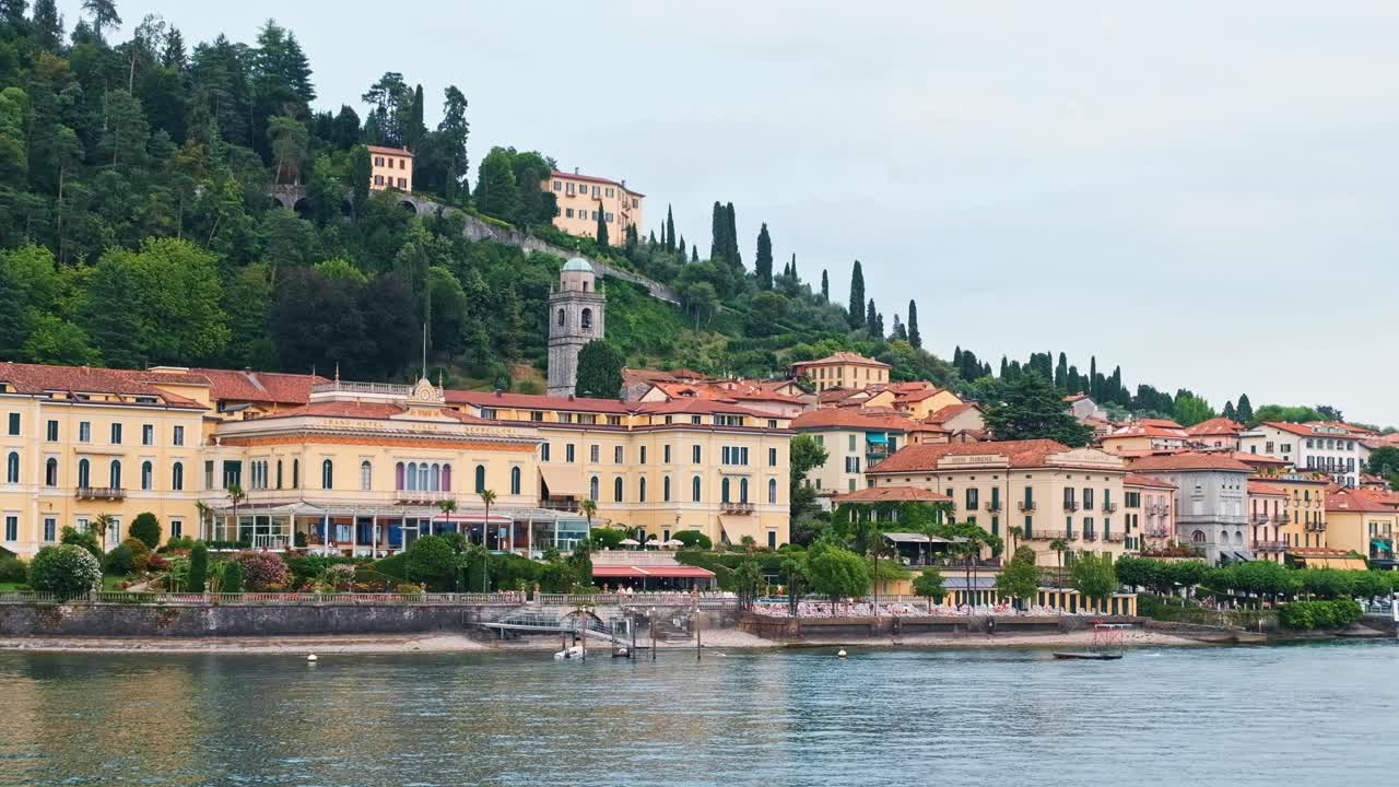LOMBARDY, ITALY - AUGUST 02, 2018: Cinematic shot of Bellagio town, Como lake and mountains from a boat