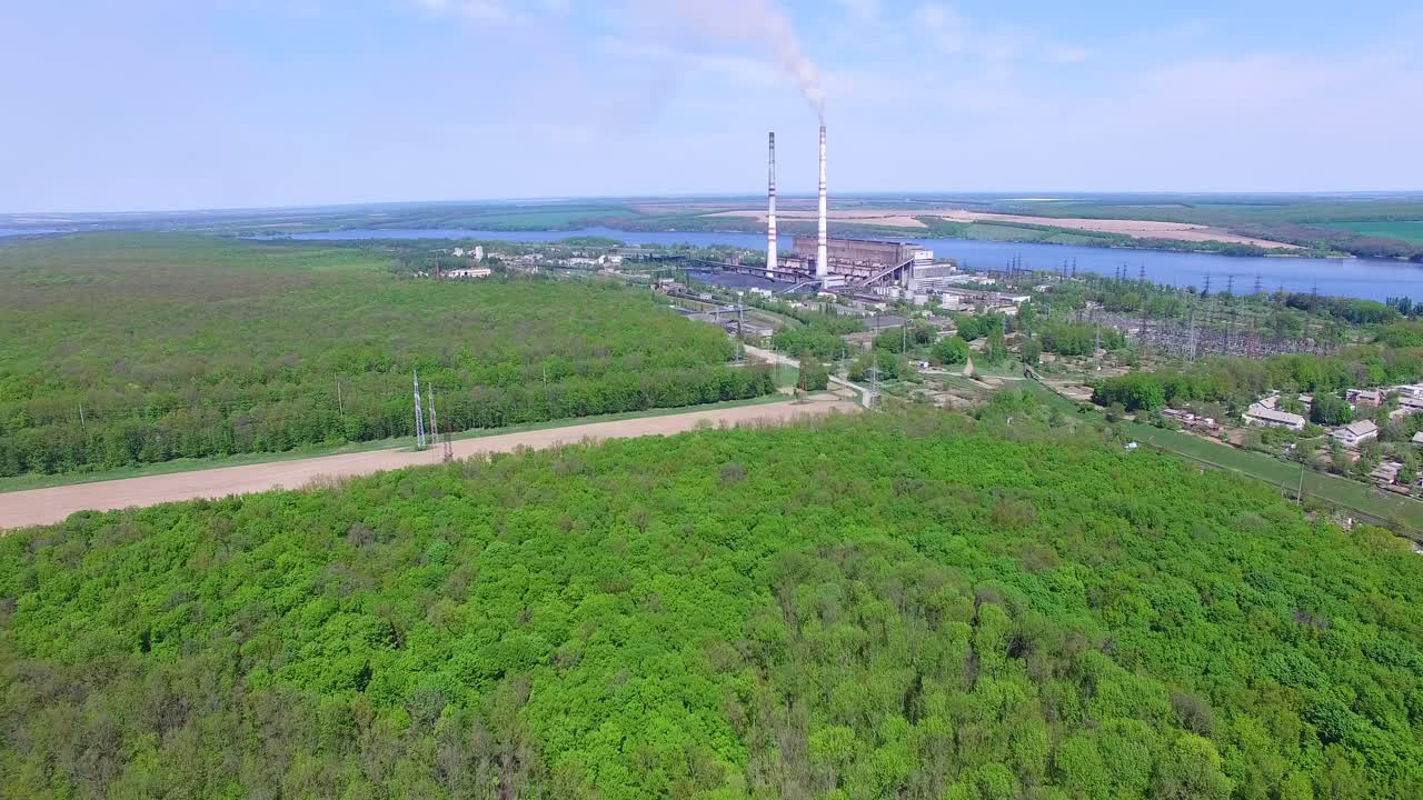 Power station with pipes. Aerial view of smoke and steam from high chimney of power plant