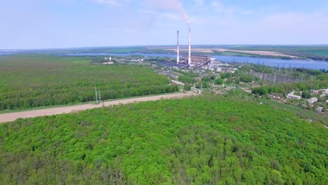 power station with pipes. aerial view of smoke and steam from high chimney of power plant