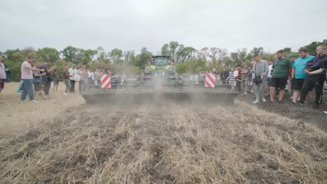 demonstration of agricultural machinery at an exhibition. tractors operate in the field, showcasing their capabilities and performance in action