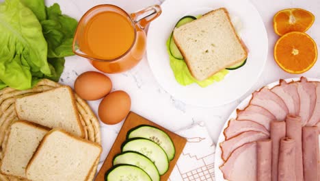 sandwich move in circle on the table with breakfast and juice - stop motion