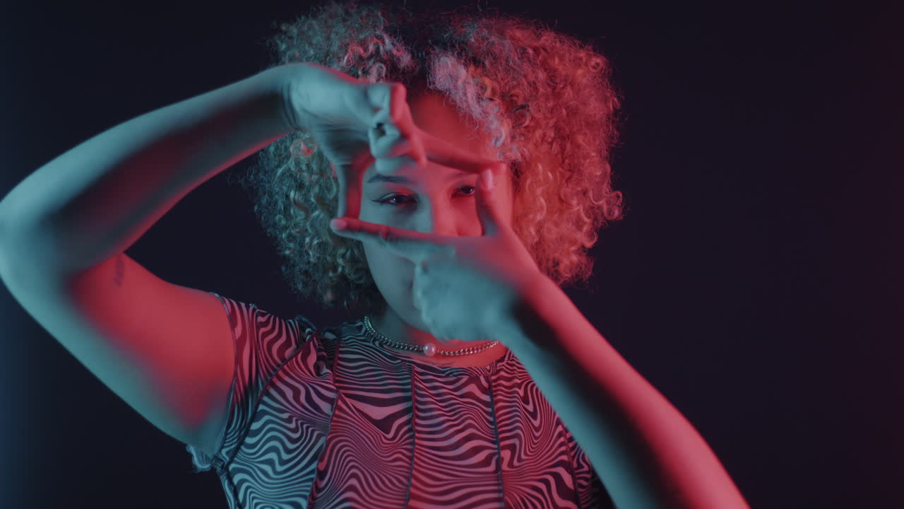 Woman Framing Her Face in Neon Light