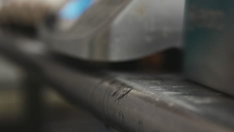 Baker-cracking-eggs-on-the-edge-of-metal-counter,-close-up