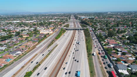 Aerial-drone-following-traffic-driving-down-710-Interstate-in-Los-Angeles,-California