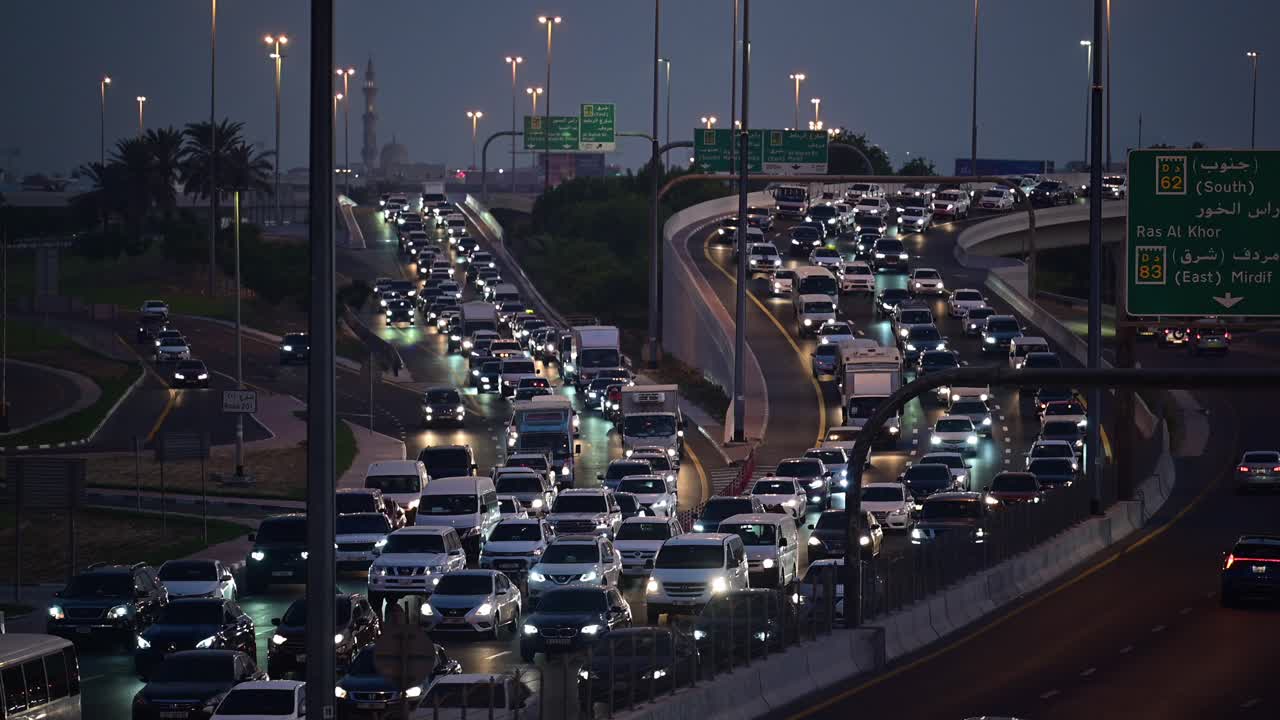 Slow-moving evening traffic on Nadd Al Hamar Road in Dubai, heading towards Sharjah, United Arab Emirates.