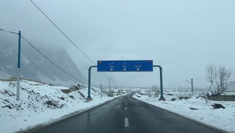 drivers view of snow covered skardu city through the highway in pakistan