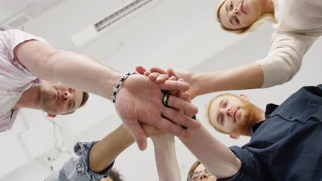 coworkers stacking hands from below