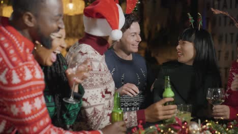 medium shot of drunk man with his friends during christmas celebrations at a bar