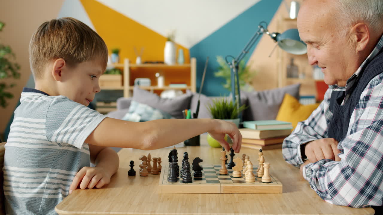 Grandfather and Grandson Playing Chess at Home