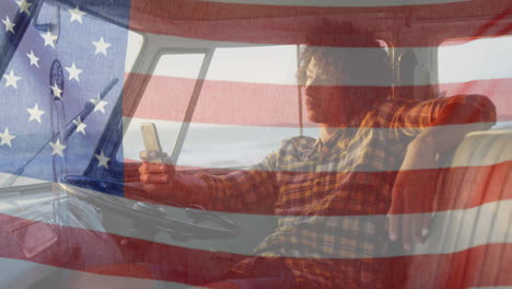 animation of american flag waving over biracial man on beach by seaside on summer holiday