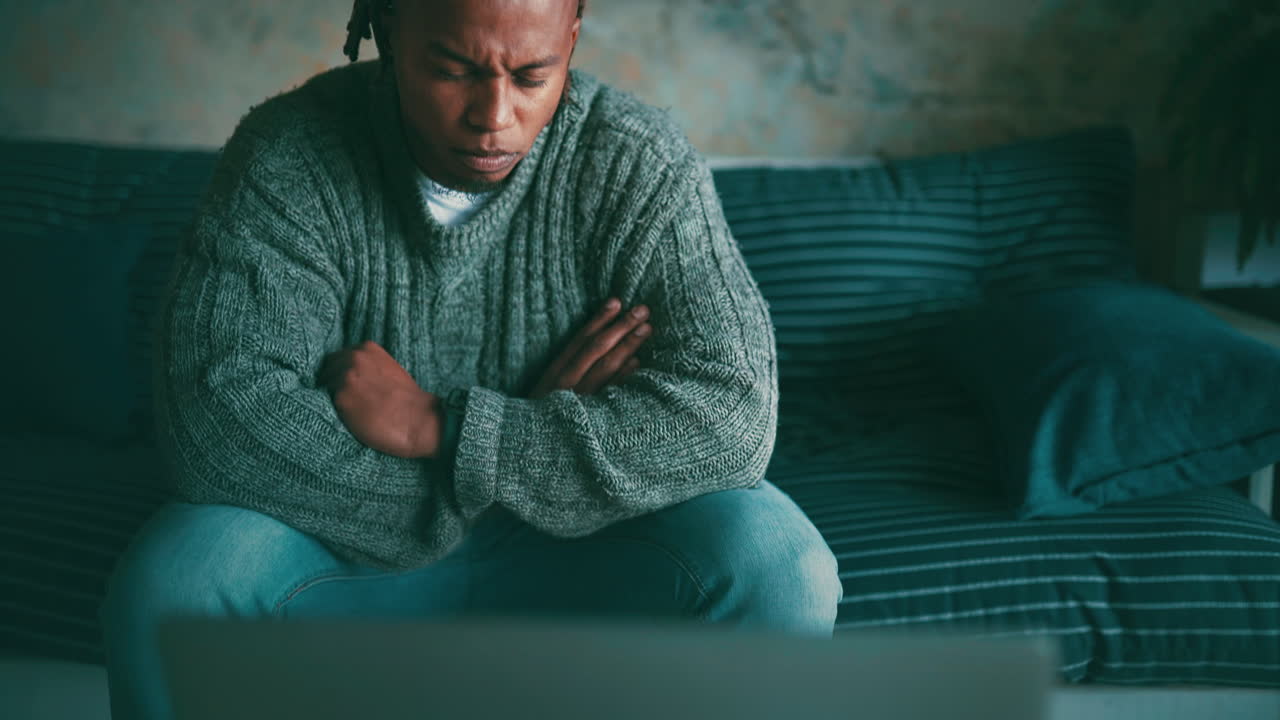 a man watching something on his laptop