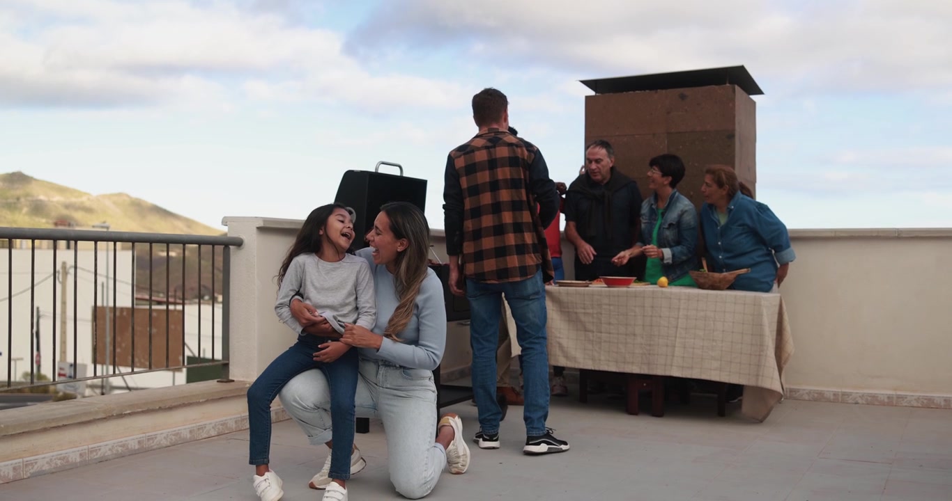 Multi-Generational Family Enjoying a Barbecue on a Rooftop Terrace