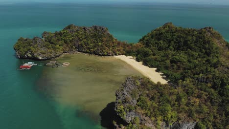 Slow-motion-drone-shot-of-a-small-mountainous-island