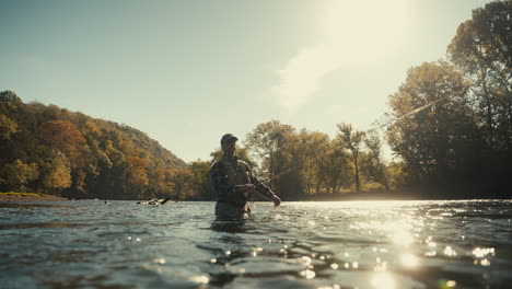 man fly fishing in a river