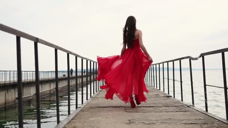 woman in red dress on a pier