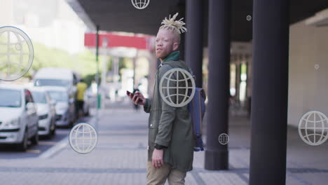 animation of globe icons over albino african american man walking while looking backward on street