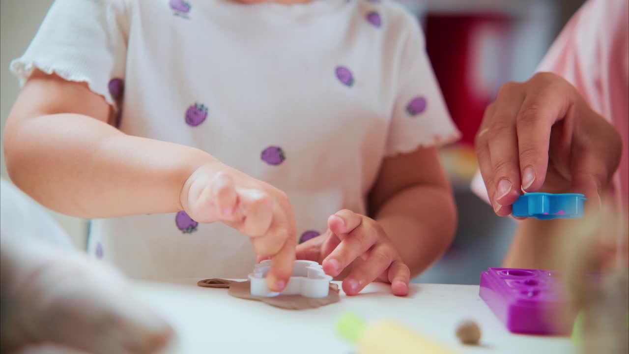 Young Child Engages in Creative Play with Colorful Materials, Fostering Imagination and Motor Skills through Hands-On Activities in a Bright Environment