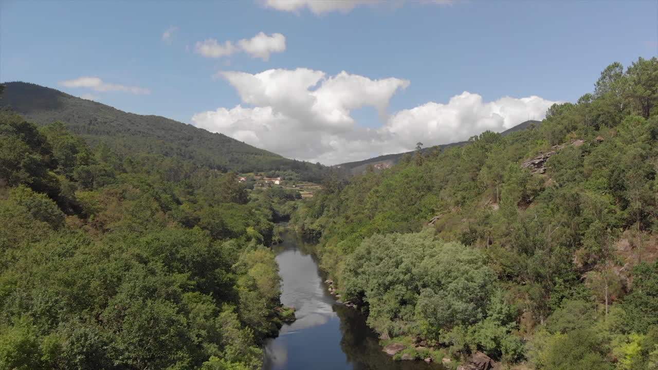 Stunning Landscape Scenery Of Rio Ulla In Galicia, Spain. Calm River Surrounded By Lush Green Trees On The Mountains Under Bright Blue Sky - aerial drone
