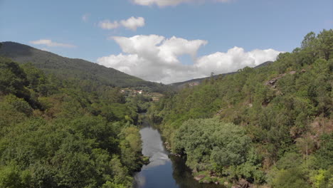 stunning landscape scenery of rio ulla in galicia, spain. calm river surrounded by lush green trees on the mountains under bright blue sky - aerial drone