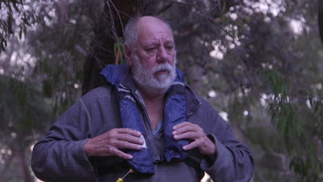 middle-aged man putting on a life jacket