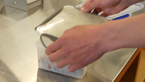 Nahaufnahme-Eines-Schülers,-Der-Den-Lunchbox-Behälter-Nach-Dem-Kochkurs-Schließt