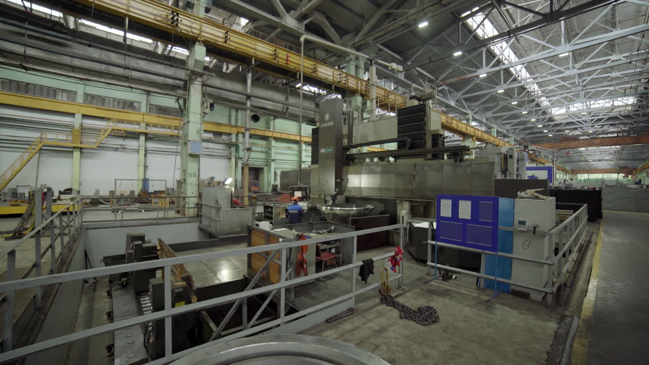 Industrial Machinery and Workers in a Large Factory