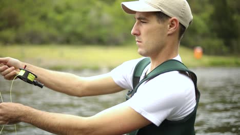 Shot-of-a-Caucasian-male-fisherman-casting-his-hook-while-Fly-Fishing-1