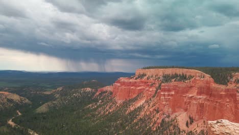 wide static shot of an impending storm over a desert canyon