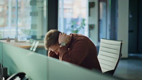 Frustrated businessman checking smartphone in office feeling despair closeup