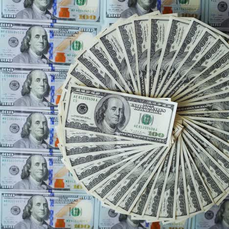 circular arrangement of one hundred dollar bills