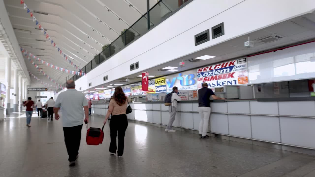 A glimpse inside the bustling Ankara bus terminal, with travelers moving towards their destinations.