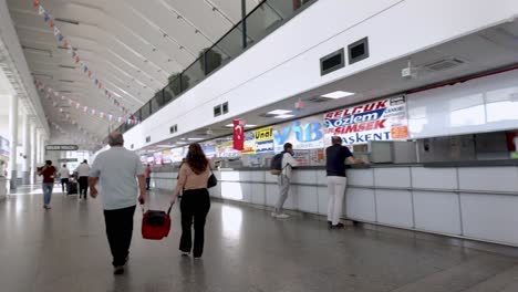 a glimpse inside the bustling ankara bus terminal, with travelers moving towards their destinations.