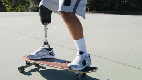 good-looking man with leg prosthesis skateboarding