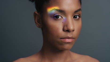 multicolor portrait beautiful african american woman with colorful light reflecting on smooth healthy skin attractive female skincare concept on grey background