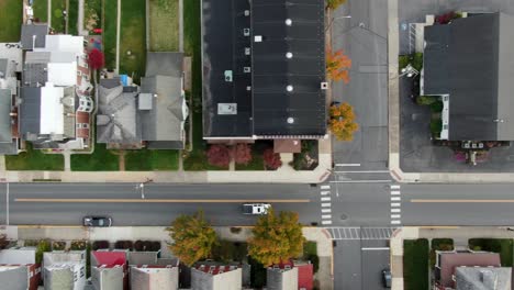 aerial top down tracking shot of car driving on street