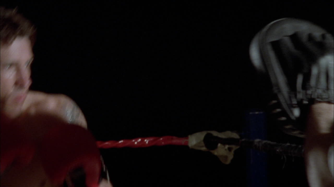 Two boxers fighting in a boxing ring 5