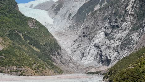 majestic franz josef glacier at the top of rugged canyon