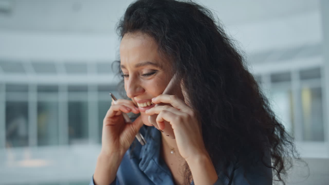 Happy manager consulting call in office. Cheerful corporate professional talking