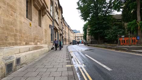 pedestrians and cyclists on a historic street