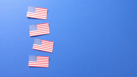 four national flags of usa lying on blue background with copy space