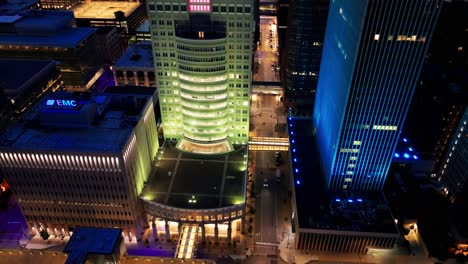 Downtown-Des-Moines,-Iowa-buildings-at-night-close-up-with-drone-video-tilting-up