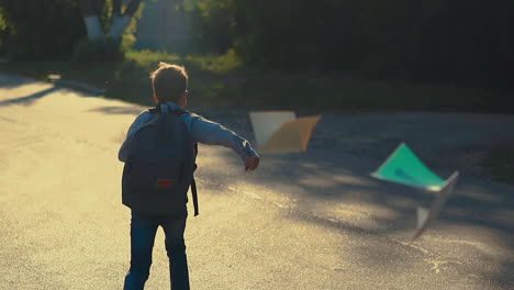 young guy jumps throwing white paper sheets and skips school