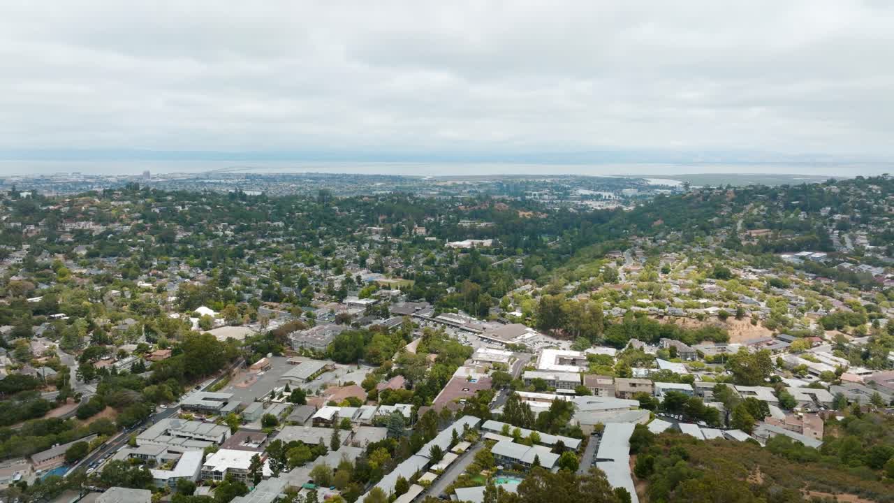 Ripresa all'indietro di un'area residenziale, circondata da alberi verdi a San Mateo, California.