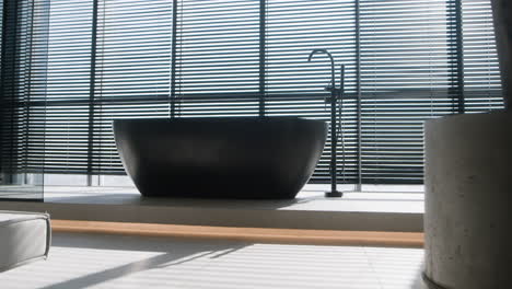 modern black bathtub in a stylish apartment bathroom