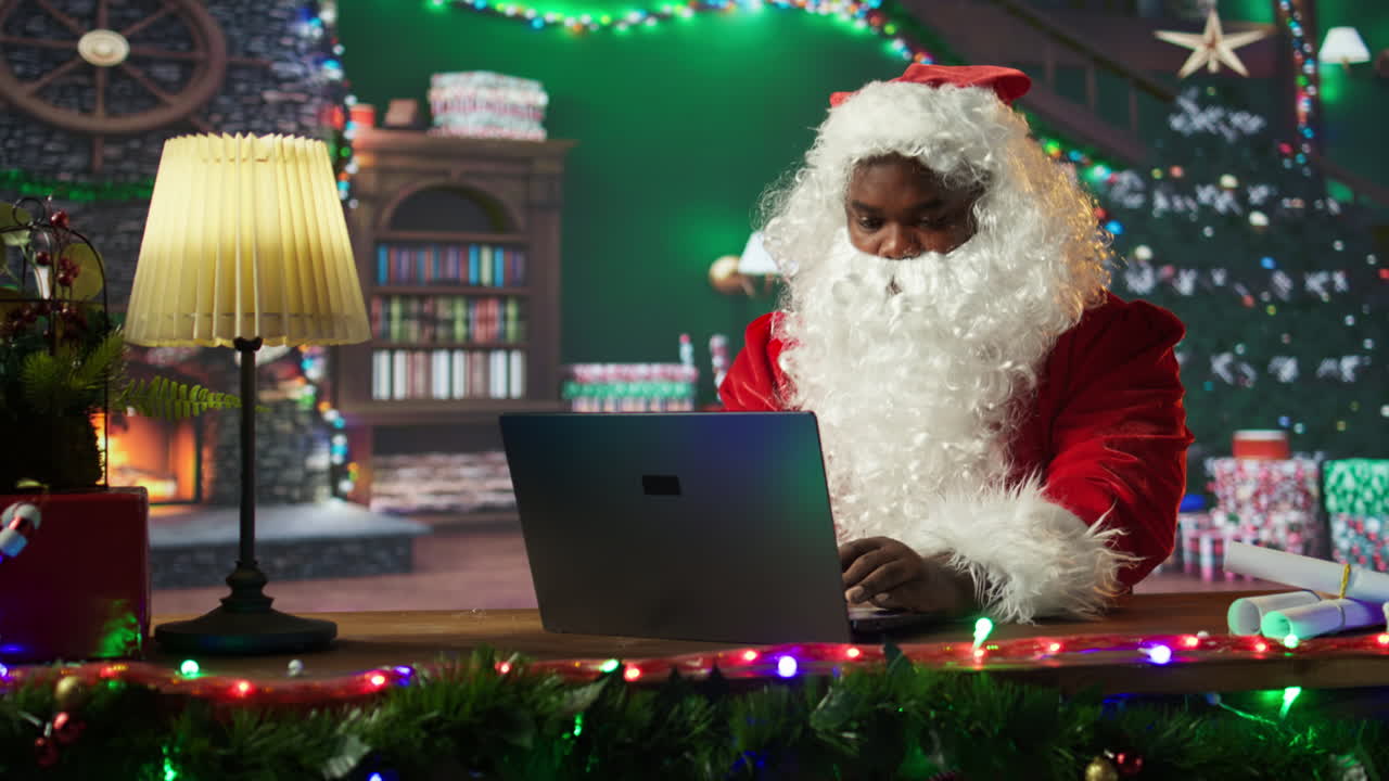 Santa Claus working on a laptop in a festive Christmas setting