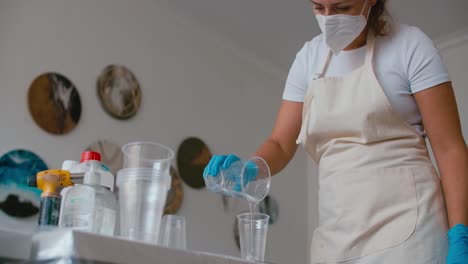 woman pouring resin in art studio