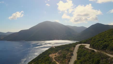 hairpin road running through mountain landscape along the coast of greece
